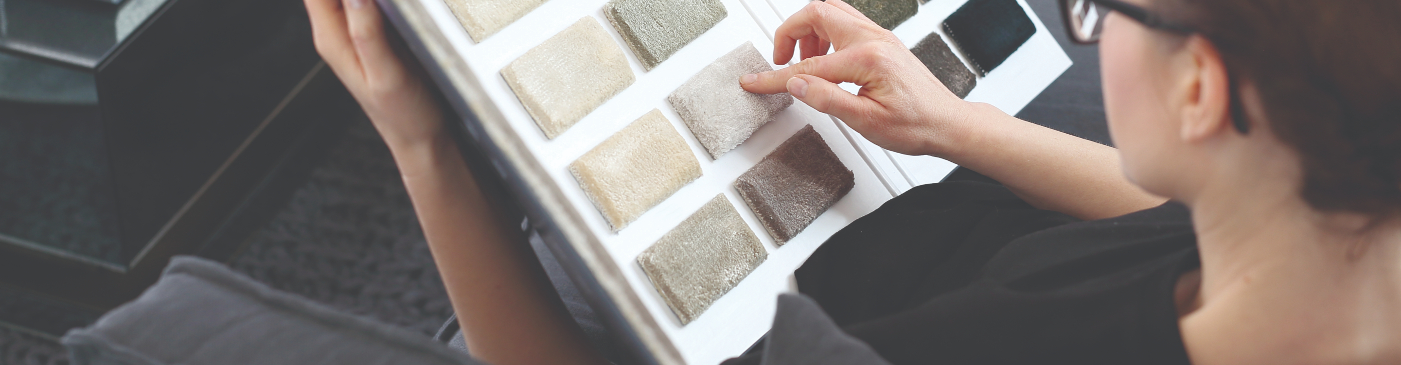 Carpet sample book with hands. 